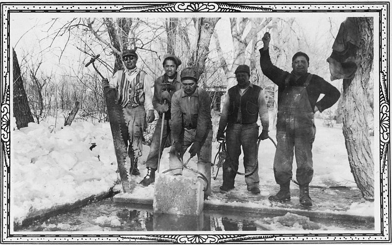 Five men cutting ice blocks
